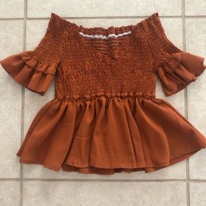 Stretch off the shoulder shirt/in burnt orange